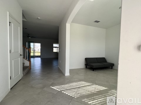 A living room with a grey sofa and a white door.
