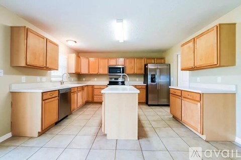 A kitchen with wooden cabinets and a central island.