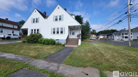 A white house with a blue door and a small porch.