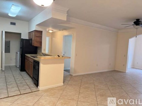 A kitchen with a refrigerator, sink, and cabinets is available for rent.