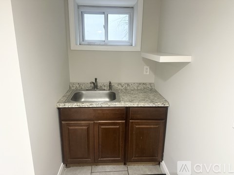 A kitchen with a sink and cabinets.