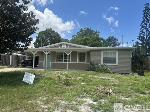 A house with a sign in front of it is for sale.