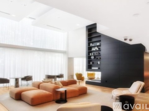 A modern living room with a black bookshelf and a white sofa.