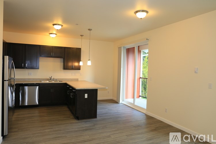 A kitchen with black cabinets and stainless steel appliances.