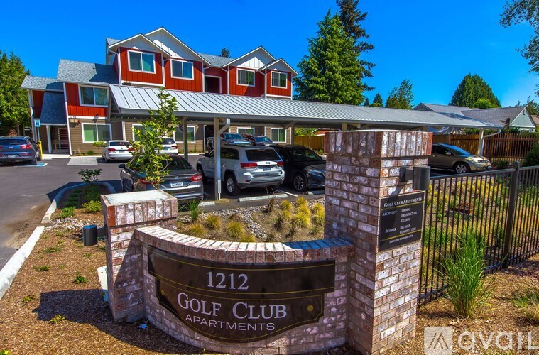 The image shows a sign for the 1212 Golf Club Apartments with a building in the background and cars parked in front.