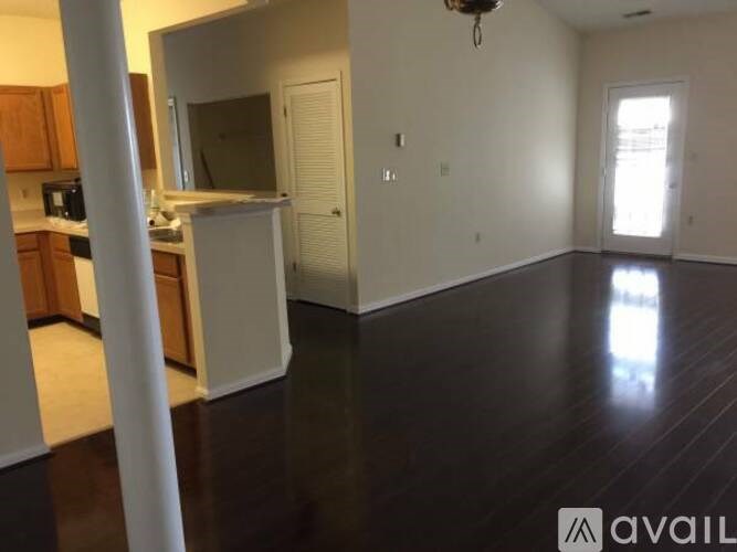 A kitchen with wooden cabinets and a white fridge.