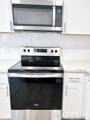 A stainless steel oven with a microwave above it.