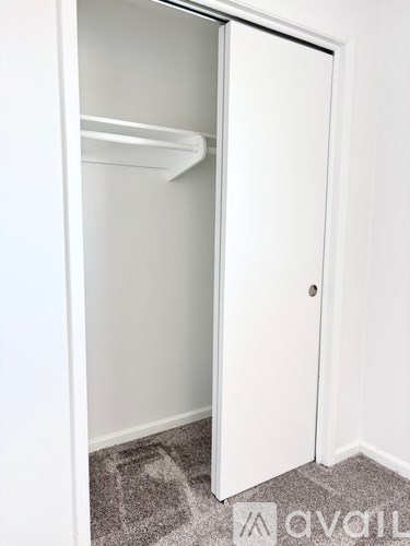 A white refrigerator with its door open in a room.