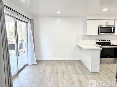 A kitchen area with a microwave, oven, and a countertop.