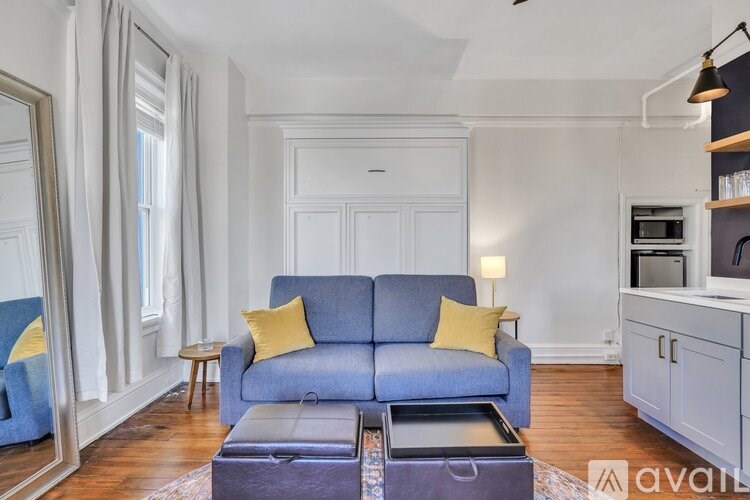A living room with a blue couch and a coffee table.