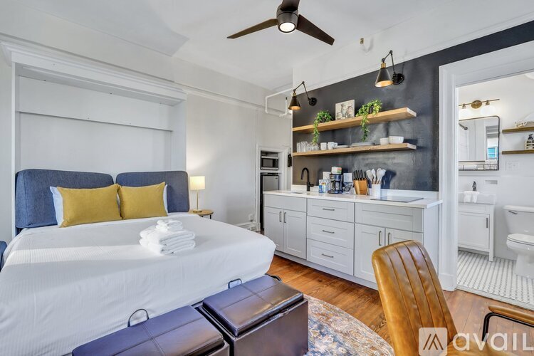 A bedroom with a large bed and a ceiling fan.