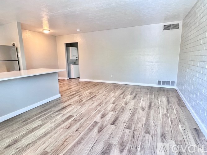 A room with wooden flooring and a white counter.