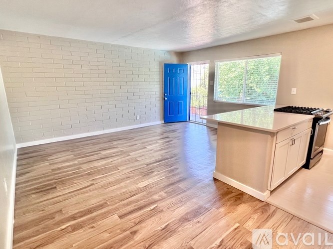 A room with a blue door and wooden flooring.