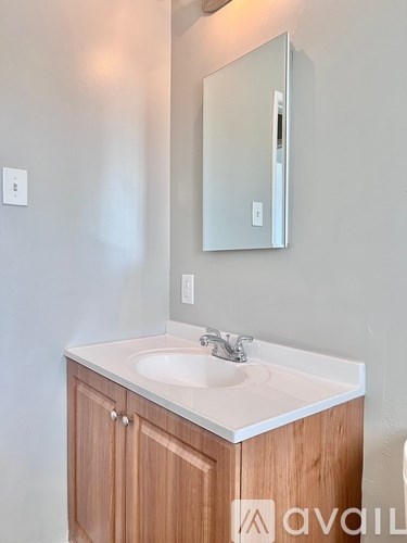 A bathroom with a sink and a mirror.