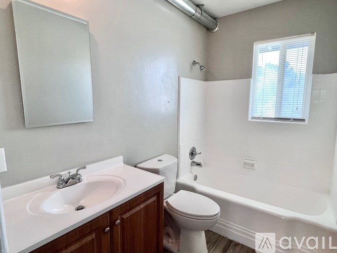 A white bathroom with a toilet, sink, and tub.