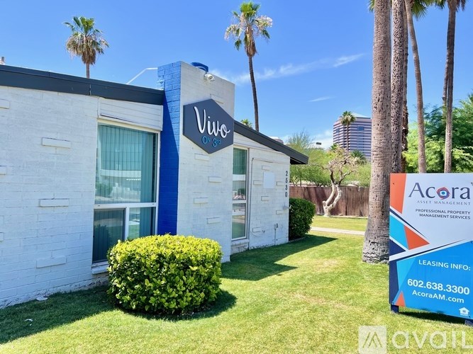 A white building with a blue trim and a sign that says Vivo.