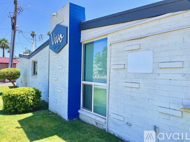 A white and blue building with a sign that says "Vivi" on it.