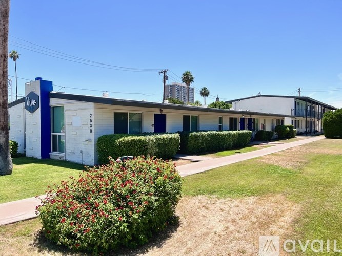 A blue and white building with a sign that says "Welcome" in front of it.