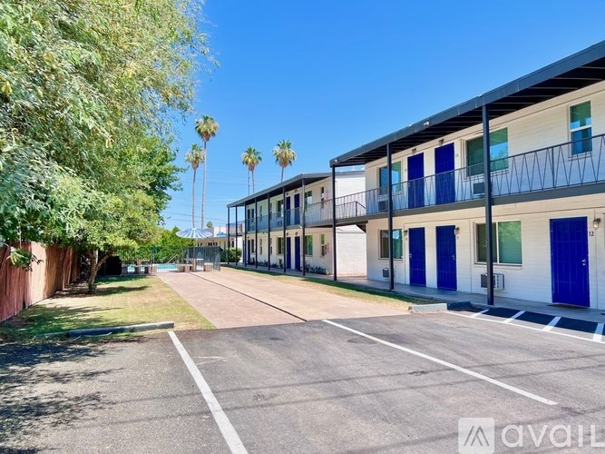 A street view of a building with blue doors and windows.