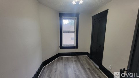 A room with a window and a door.