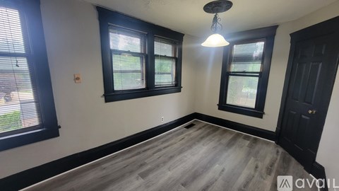 A room with a wooden floor and a ceiling fan.