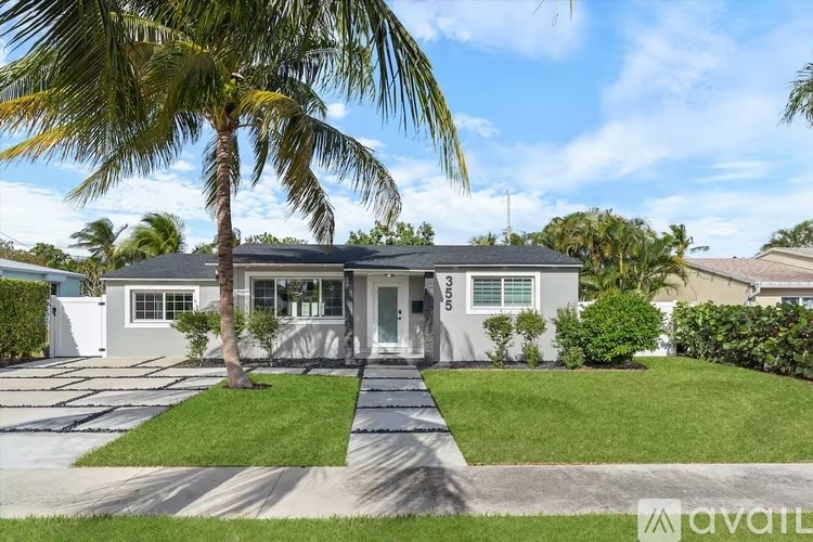 A house with a palm tree in front of it.