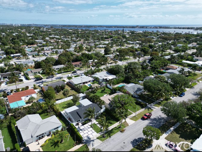 A bird's eye view of a residential area with houses and trees.