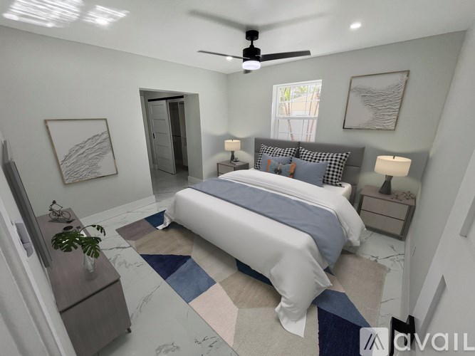 A bedroom with a bed, nightstands, and a ceiling fan.