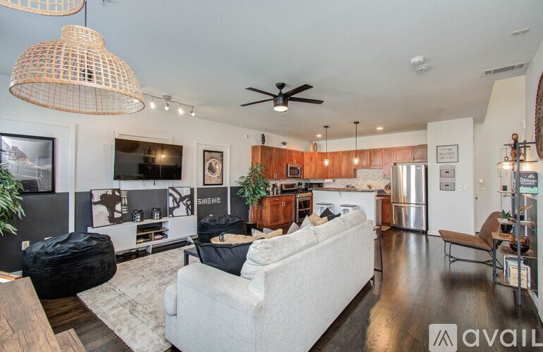 A living room with a white couch and a wooden table.