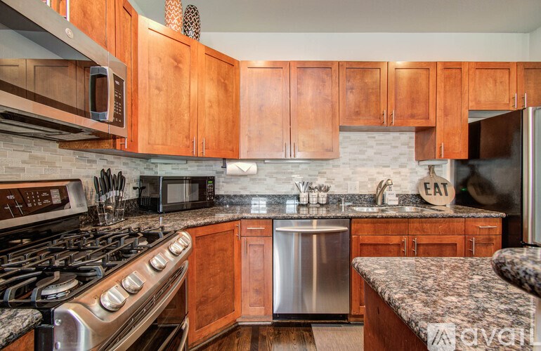 A kitchen with wooden cabinets and a stainless steel dishwasher.