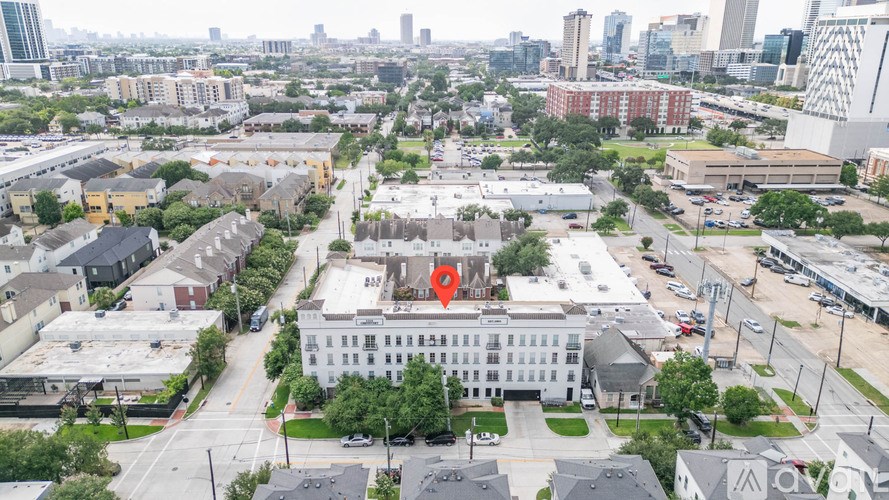 A red object is in the middle of a white building.