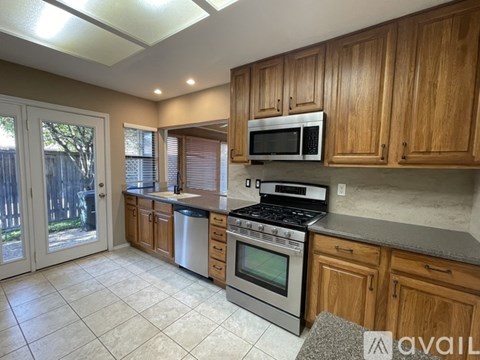 A kitchen with wooden cabinets and stainless steel appliances.