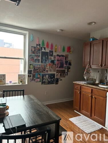 A kitchen with a table and chairs in front of a window.
