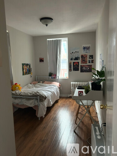 A bedroom with two beds and a wooden floor.