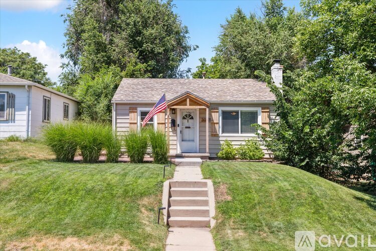 A house with a flag on the front porch is for sale.