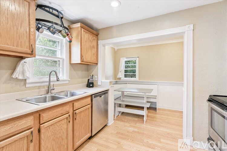 A kitchen with wooden cabinets and a white sink.