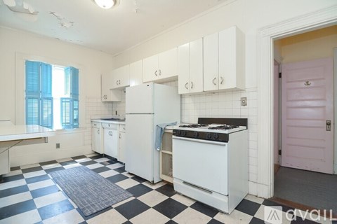 A kitchen with black and white checkered floor.