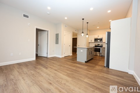 A kitchen area with a refrigerator, microwave, and oven.