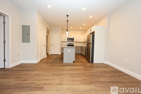 A kitchen with wooden floors and white walls.