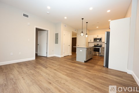 A kitchen area with a refrigerator, microwave, and oven.