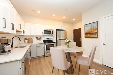 A kitchen with a table and chairs in the middle of it.