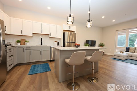 A kitchen with a bar stool and a counter.
