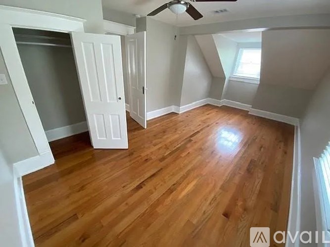 A room with wooden floors and white walls.