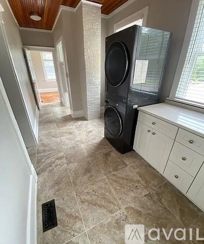 A room with a speaker and a window.