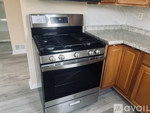 A modern black stove with a digital clock on the front.