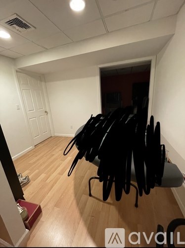 A room with a white door and a red box on the floor.