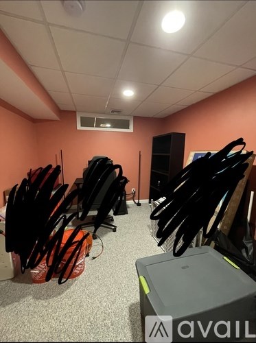 A room with a lot of black items on the floor.