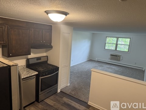 A kitchen with a black oven and a window with bars.