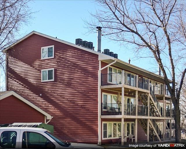 a red house with a car parked in front of it