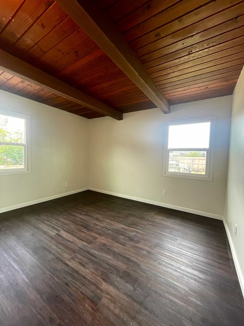 A room with wooden floors and a wooden ceiling.